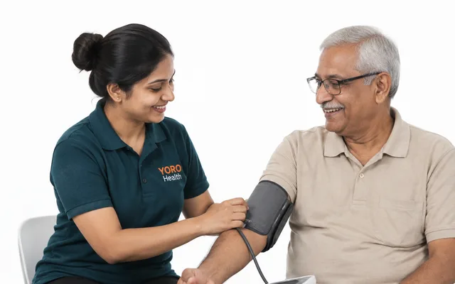 A nurse checking an older man’s blood pressure